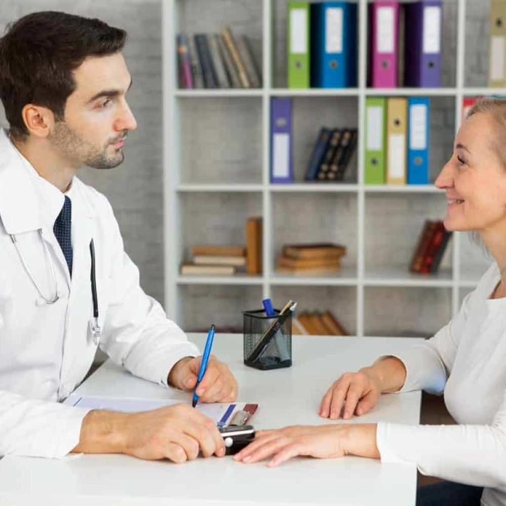 Home Care Services - Medical Appointments. medical staff consulting with older woman at desk